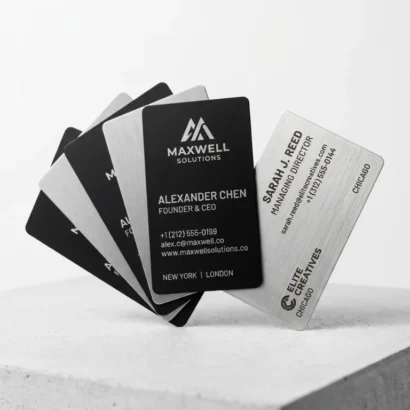 Custom luxury matte black and brushed steel metal business cards studio view for Advertising Point UAE